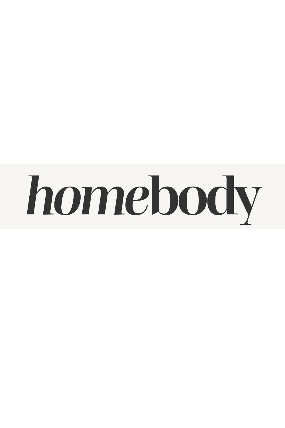 Minimal typographic word art displaying the word homebody, representing comfort, coziness, and a love for staying in and creating a meaningful home life.