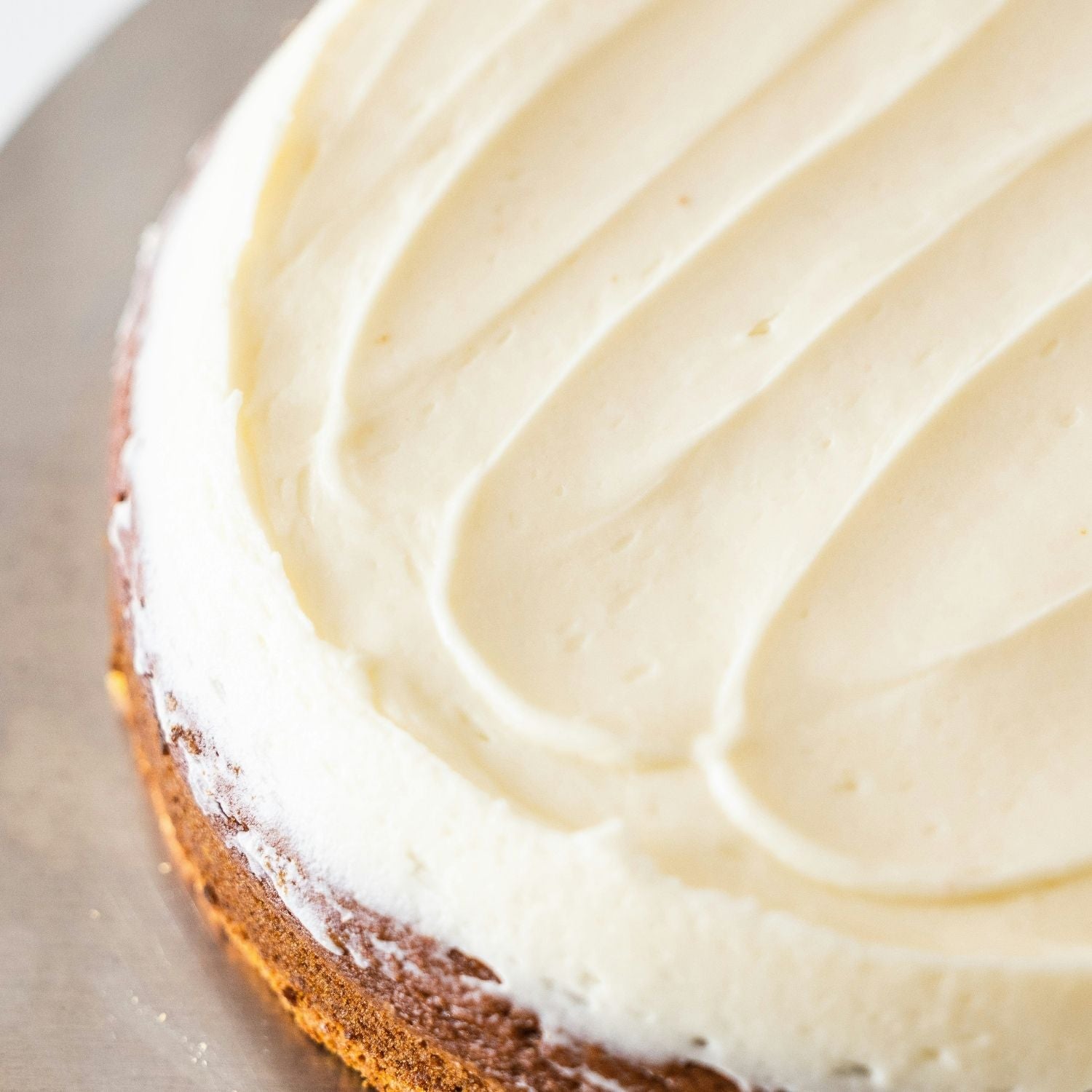 Soft, minimalist close-up of a frosted cake representing comfort, creativity, and the simple pleasures of home and hobbies.