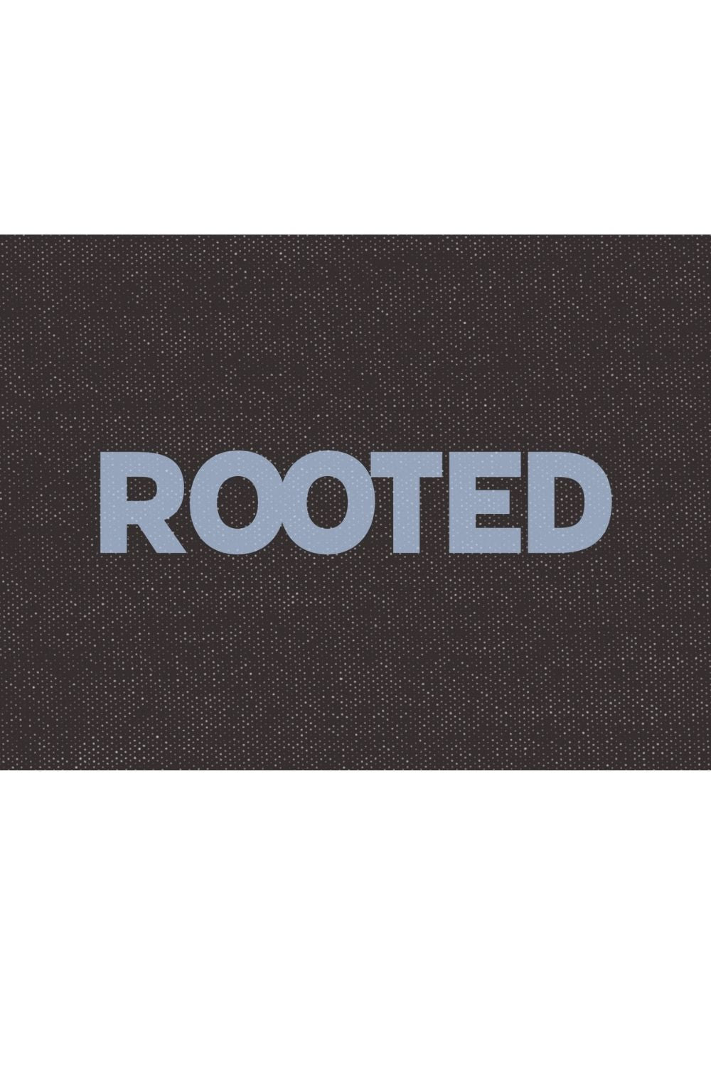 Typography word tile reading rooted on a textured background, symbolizing stability, grounding, and a sense of home.