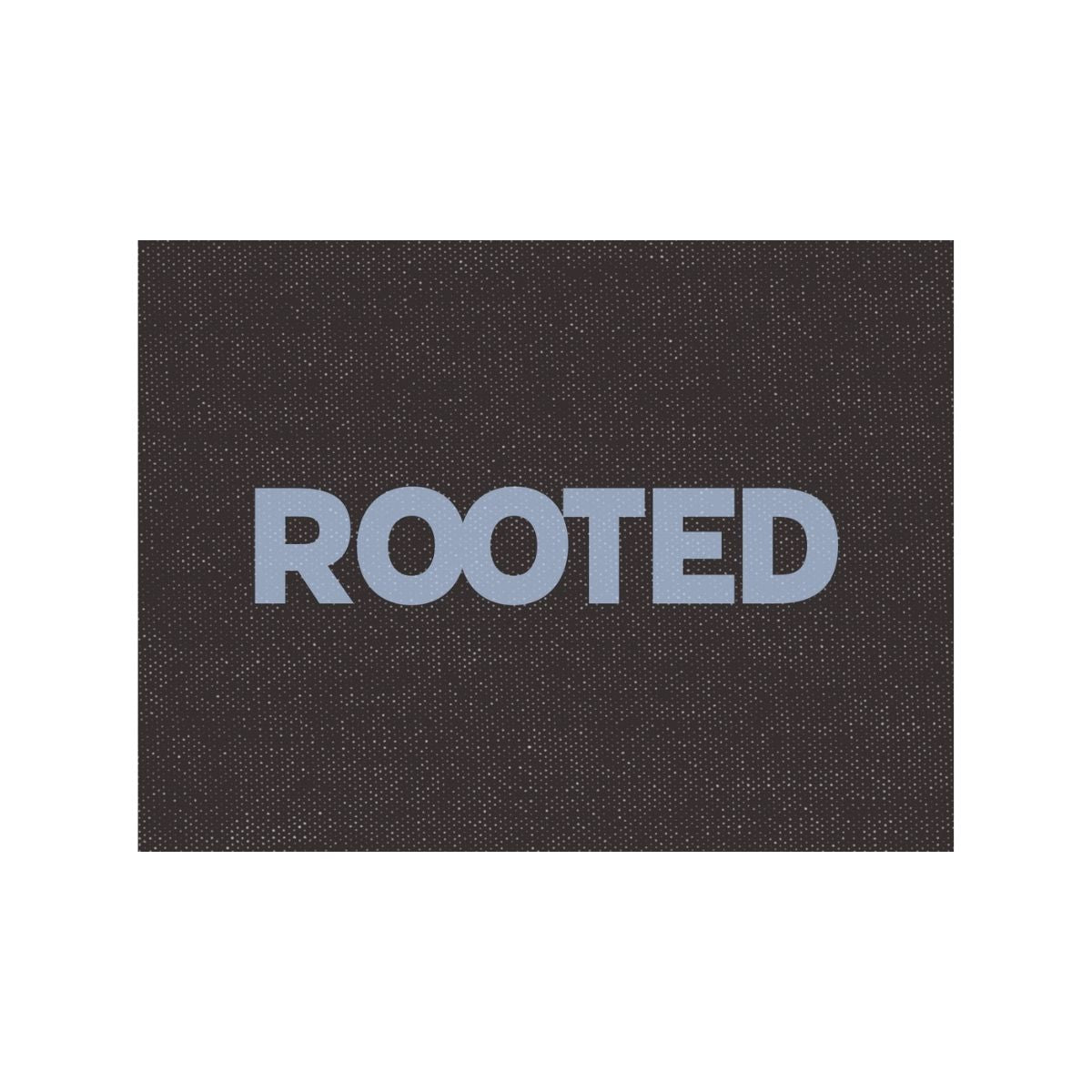 Typography word tile reading rooted on a textured background, symbolizing stability, grounding, and a sense of home.
